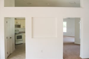 Interior view of a country-style home showing a built-in wall niche and adjoining open living space.