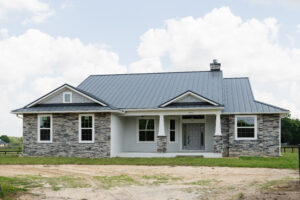 Custom country style home with metal roof and stone exterior in Ocala Florida
