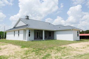 rear exterior of custom country home with covered patio and open yard