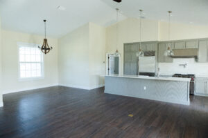 open concept living room and kitchen with high ceilings and natural light