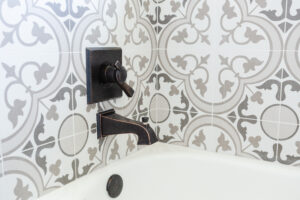 decorative tile shower wall with modern fixture in custom bathroom