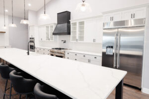 large quartz kitchen island in modern farmhouse luxury home with open layout
