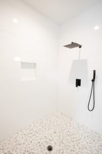 minimalist walk in shower with rainfall shower head and light tile