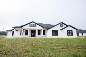 modern farmhouse exterior with white siding black windows and covered porch