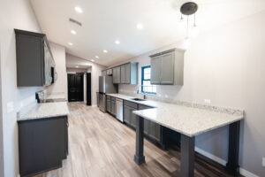 open concept modern farmhouse kitchen with large island and pendant lighting