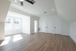 Second-floor flex room with sloped ceiling and built-in storage in a two-story custom farmhouse in Morriston, FL