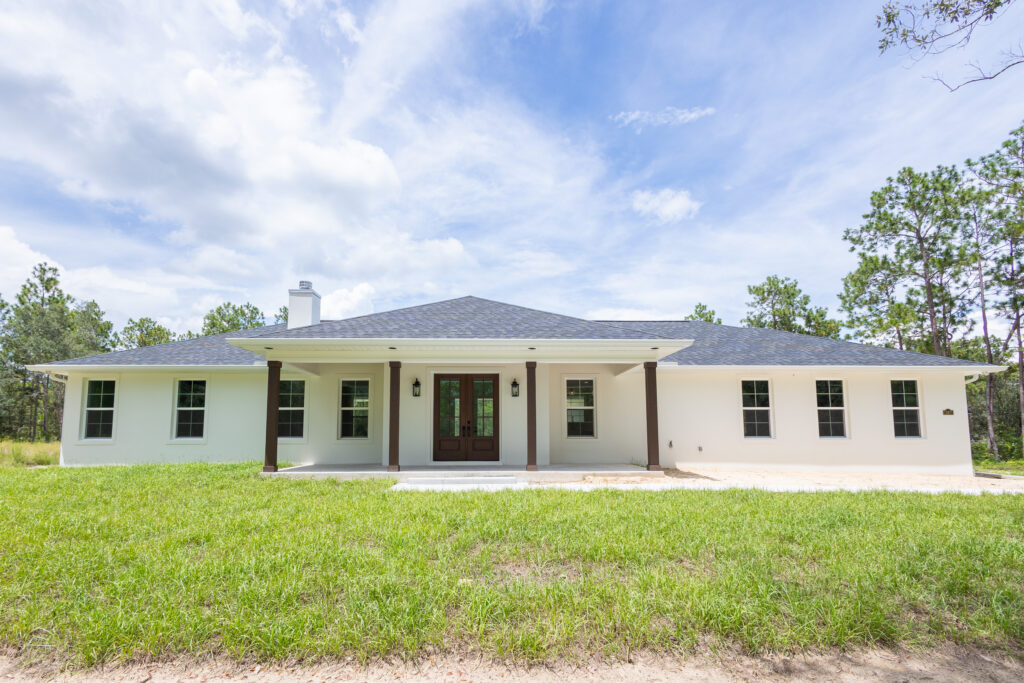 Modern farmhouse custom home exterior in Morriston Florida by Curington Homes