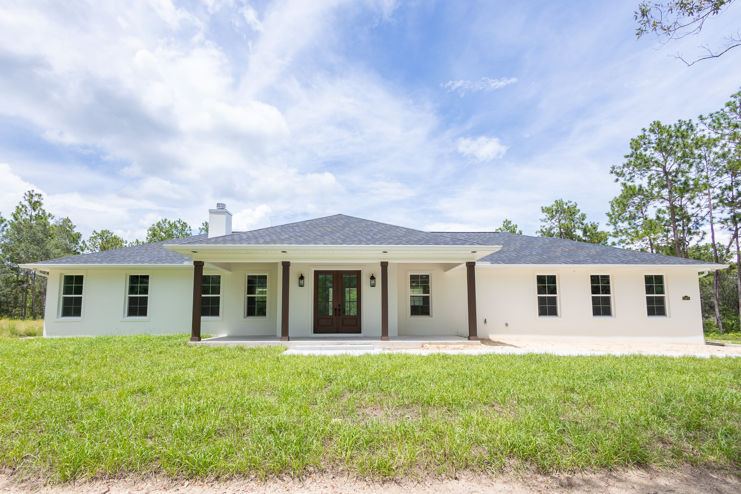 Modern farmhouse custom home exterior in Morriston Florida by Curington Homes