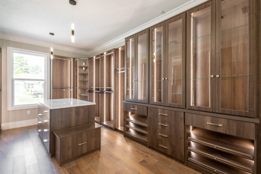 Luxury storage room with custom wood cabinetry and built-in shelving in a Juliette Falls custom home by Curington Homes.