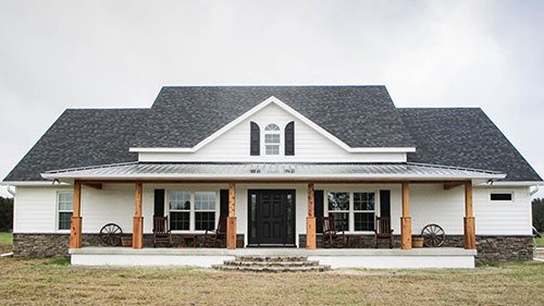 A white farmhouse style home with black shutters in Ocala, Florida