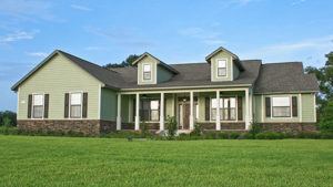A rendering of a green modern farmhouse with porch in Ocala, Florida
