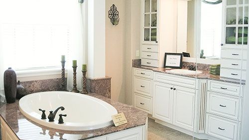 A large spa tub stands across the vanity in this modern farmhouse bathroom.